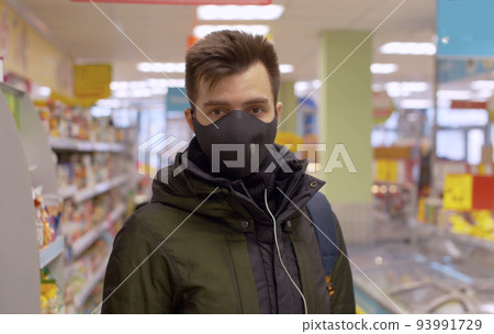 A man standing in the supermarket 93991729