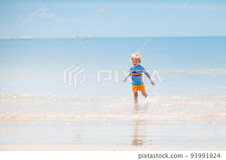 Kids playing on beach. Children play at sea. 93991924