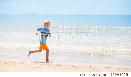 Kids playing on beach. Children play at sea. Kids playing on beach. Children play at sea. 93991926