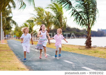 Children walking on sea promenade street. 93991932