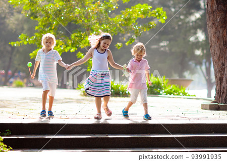 Kids in sunny summer park. Kids in sunny summer park. 93991935