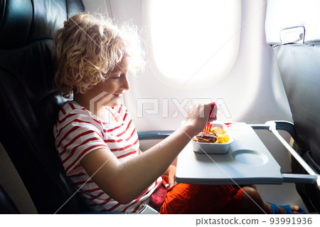 Child in airplane. Kids fly. Children flight meal 93991936