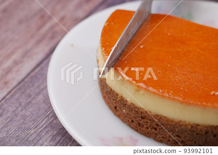 Caramel custard pudding on a plate on table  93992101