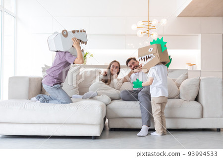 Family playing dinosaurs at home 93994533