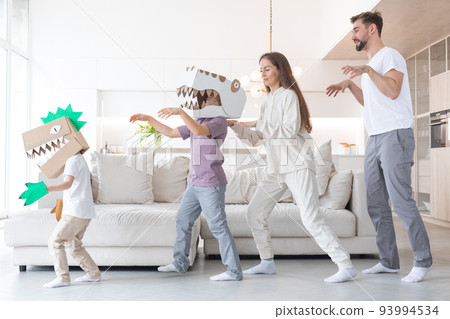 Family playing dinosaurs at home 93994534