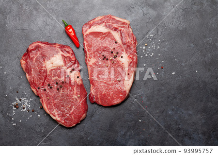 Two raw ribeye beef steaks 93995757