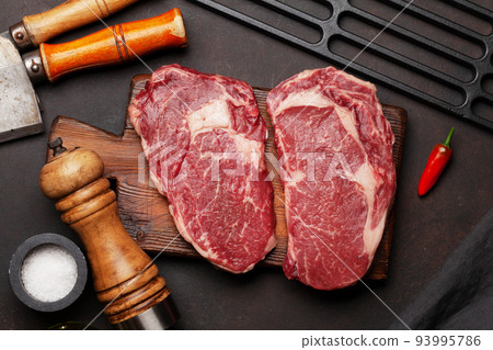 Two raw ribeye beef steaks 93995786