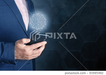 Online business. businessman holding the cell mobile phone with sign the global network on dark blue background. copy space. internet, cellular technology concept Online business. businessman holding the cell mobile phone with sign the global network on dark blue background. copy space. internet, cellular technology concept 93995992
