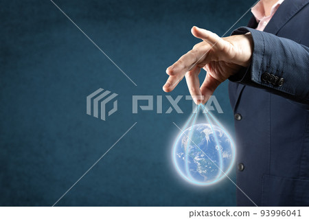 businessman holds planet earth. corporations run the world globalization concept. blue background. copyspace businessman holds planet earth. corporations run the world globalization concept. blue background. copyspace 93996041