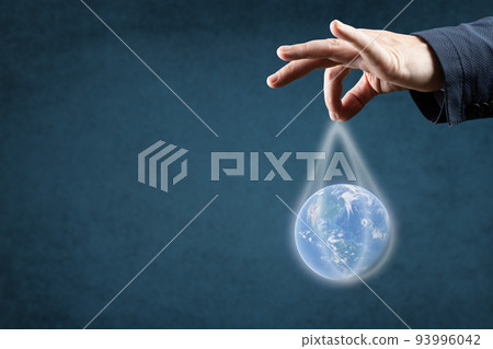 globalization, Energy and ecology concept. man's hand in suit holds the planet earth by the strings. blue background, copy space globalization, Energy and ecology concept. man's hand in suit holds the planet earth by the strings. blue background, copy space 93996042