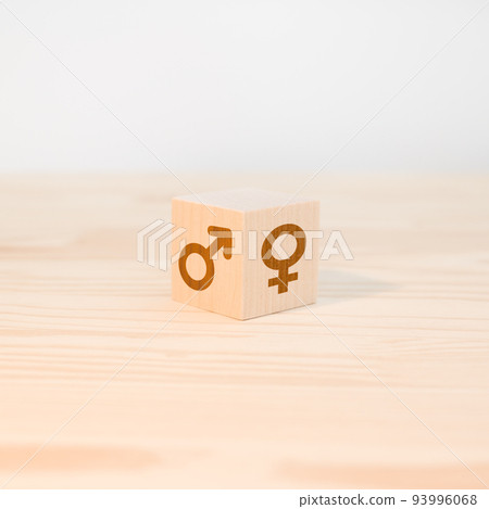 wooden cube with male and female symbols. the concept of gender difference and equality. square image. Male and female gender icons or symbols on two sides of a wooden cube. Gender equality concept. 93996068