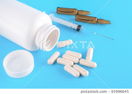 Pills, Syringe, ampoules for injections on a blue medical background. close up, top view. 93996645