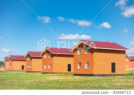 new cottage settlement. a row of newly built two-story houses. concept of construction of low-rise buildings 93996713