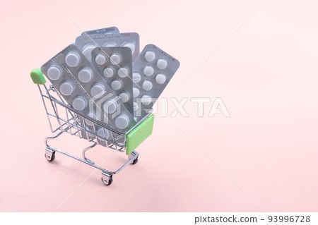 Grocery cart with pills, pharmacy shopping concept. Pills in the little grocery cart 93996728