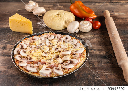 Pizza Cooking Ingredients. Raw homemade pizza on wooden rustic table. Pizza Cooking Ingredients. Raw homemade pizza on wooden rustic table. 93997292