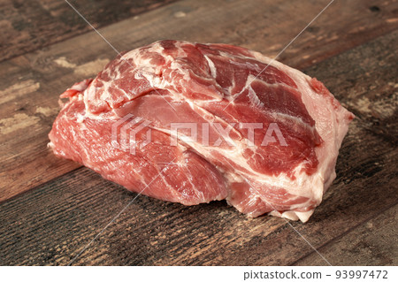 Raw pork meat on dark wooden rustic background. Piece of raw meat ready for preparation 93997472