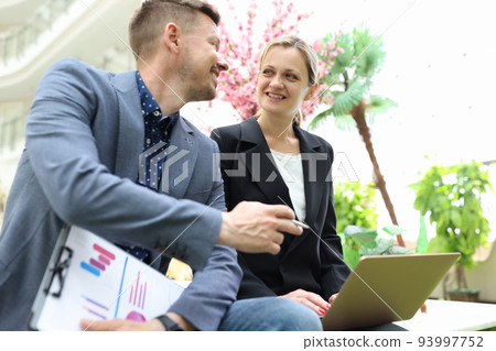 Two business happy smiling people are discussing work and development of startup Two business happy smiling people are discussing work and development of startup 93997752