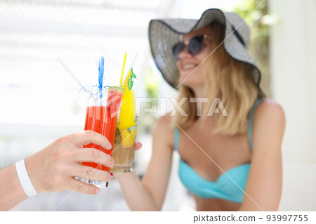 Happy couple in love toasting at resort in hotel 93997755