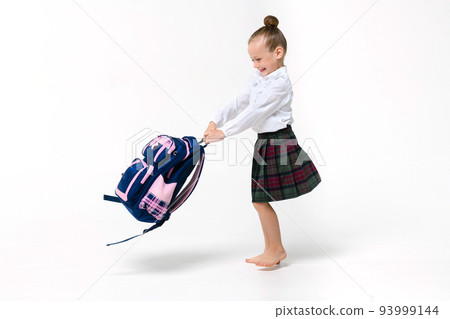 Girl spinning with a huge school backpack on a white background 93999144