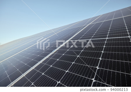 Renewable, clean and green energy with solar panels for future eco electricity from the sun against a blue sky mockup. Photovoltaic power system converting sunlight through cells for sustainability 94000213