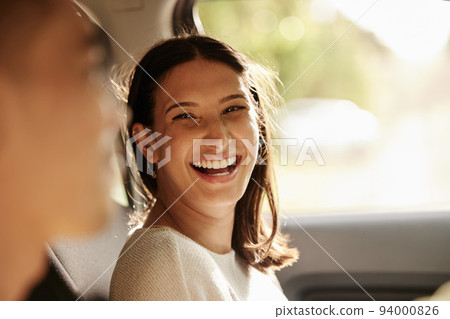 Happy, cheerful and laughing woman enjoying a road trip, holiday or vacation with her boyfriend in the car. Latino woman having fun in a vehicle while on a journey to a romantic destination Happy, cheerful and laughing woman enjoying a road trip, holiday or vacation with her boyfriend in the car. Latino woman having fun in a vehicle while on a journey to a romantic destination 94000826