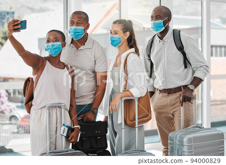 Travel people taking selfie with covid face mask at the airport on their trip, travel or holiday overseas. Group of people or friends with suitcase, phone and social media memories while on vacation Travel people taking selfie with covid face mask at the airport on their trip, travel or holiday overseas. Group of people or friends with suitcase, phone and social media memories while on vacation 94000829