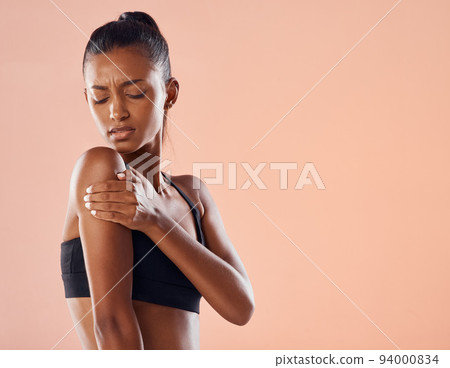 Life insurance for fitness trainer with sports injury in activewear on world health day on paper background. Worried girl exercising in gym has painful arm muscle, concerned about self care wellness. Life insurance for fitness trainer with sports injury in activewear on world health day on paper background. Worried girl exercising in gym has painful arm muscle, concerned about self care wellness. 94000834