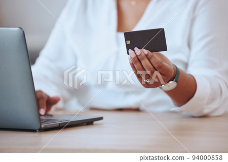 Credit card, laptop and finance with a businesswoman paying her bills and mortgage online. Black woman ordering, hands and banking as she saves money in her bank account for a budget or loan. 94000858