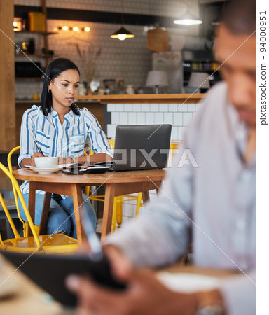 Working, reading and typing in a coffee shop with a digital worker writing an email on a computer. Job, career focus of a woman startup entrepreneur or digital web writer in a cafe or restaurant Working, reading and typing in a coffee shop with a digital worker writing an email on a computer. Job, career focus of a woman startup entrepreneur or digital web writer in a cafe or restaurant 94000951