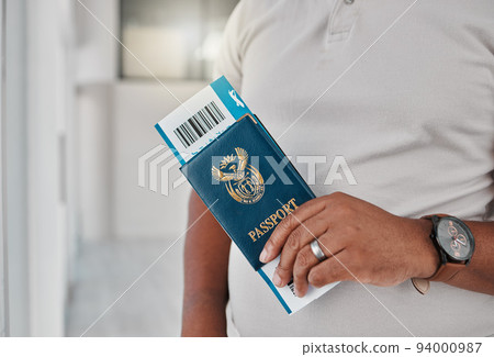 Man at airport with passport, travel visa and ticket for plane flight of international immigration. Hands of tourist, traveller and passenger waiting for airplane departure with identity documents 94000987