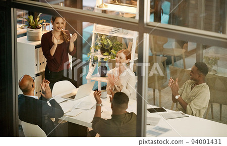 Successful team clapping hands, cheering during deal or meeting in modern office. Diverse group motivated by a plan, goal or strategy. Coworkers with a vision excited after planning a mission 94001431