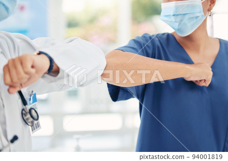 Healthcare, hospital and women in medicine elbow greeting and communication in covid pandemic. Social distancing, face mask and safety against virus at work, doctor and nurse greet at medical center. Healthcare, hospital and women in medicine elbow greeting and communication in covid pandemic. Social distancing, face mask and safety against virus at work, doctor and nurse greet at medical center. 94001819