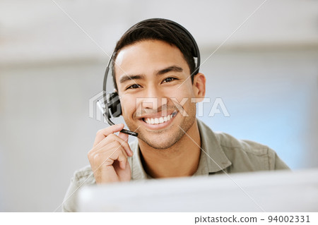 Smiling, friendly call center agent with headset for online consulting in an IT tech agency. Face of male ecommerce support professional offering virtual assistance to web user or contact us hotline Smiling, friendly call center agent with headset for online consulting in an IT tech agency. Face of male ecommerce support professional offering virtual assistance to web user or contact us hotline 94002331