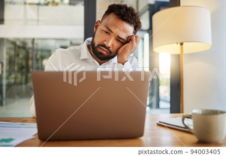 Stress, burnout and sad eyes of businessman on laptop working late on an email at house or home. Headache, mental health and disappointed worker working on finance, accounting or financial tax Stress, burnout and sad eyes of businessman on laptop working late on an email at house or home. Headache, mental health and disappointed worker working on finance, accounting or financial tax 94003405