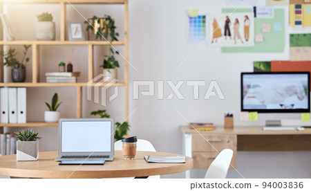 Empty business office interior with a laptop and computer on a desk or table with a professional design. An agency workspace or workplace with equipment connected to the internet or company wifi Empty business office interior with a laptop and computer on a desk or table with a professional design. An agency workspace or workplace with equipment connected to the internet or company wifi 94003836