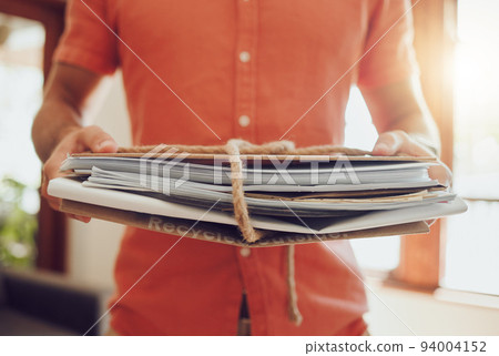 Holding recycle and paper stack closeup of hands inside environmentally friendly home. Sustainable, waste management and eco friendly person who cares about the earth and rubbish reuse. 94004152