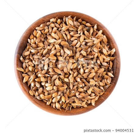 Utsho suneli seeds in wooden bowl, isolated on white background. Trigonella caerulea or blue fenugreek. Top view. Utsho suneli seeds in wooden bowl, isolated on white background. Trigonella caerulea or blue fenugreek. Top view. 94004531
