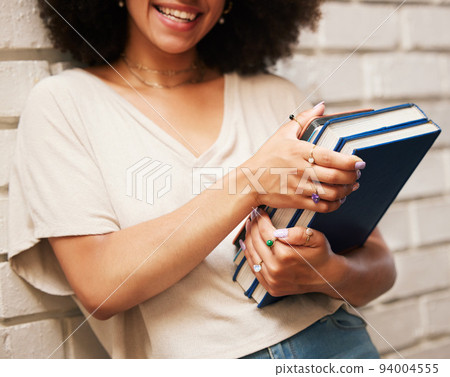 Happy student with books on university campus, scholarship for education at school and smile for learning at library. African girl studying law, doing research and motivation for future career 94004555