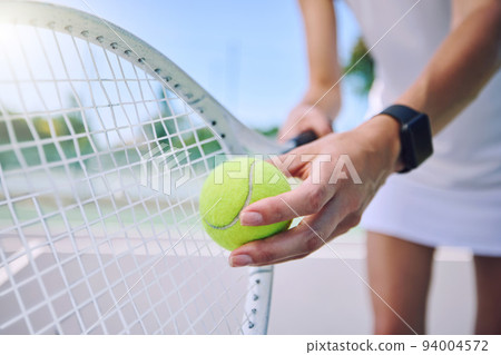 Closeup tennis ball, racket and sport for fit, active and healthy player training and exercising for practice. Professional player getting ready to serve for routine court workout and exercise match Closeup tennis ball, racket and sport for fit, active and healthy player training and exercising for practice. Professional player getting ready to serve for routine court workout and exercise match 94004572
