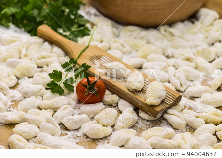 Homemade gnocchi, prepared on the table with ingredients. 94004632