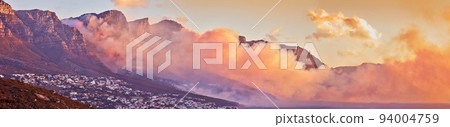 Beautiful sunrise panorama with mist over a mountain. Foggy weather along the coast at dawn. Breathtaking view of a peaceful suburb surrounded by majestic valley and scenic landscape in nature 94004759