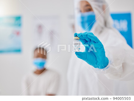 Covid, corona virus vaccine or vaccination with healthcare worker hands showing liquid glass container or bottle. Medical doctor preparing a coronavirus prevention dosage shot for patient in hospital 94005503