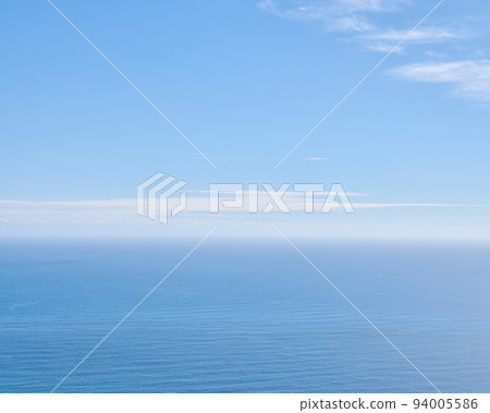 Peaceful, calm and soft ocean view with empty sea, blue sky copy space and background in summer. Serene aerial landscape and copyspace of an open aqua surface seascape with light cloud on the horizon 94005586