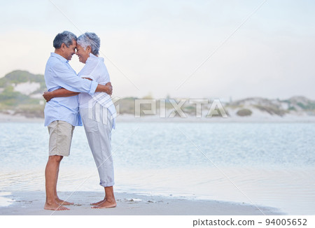 Senior couple retirement, beach holiday and travel vacation at sea with hug, love and care together. Elderly people in happy marriage, intimate hug and romantic relationship relax at ocean outdoor Senior couple retirement, beach holiday and travel vacation at sea with hug, love and care together. Elderly people in happy marriage, intimate hug and romantic relationship relax at ocean outdoor 94005652