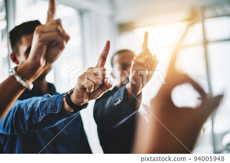 Business people holding up fingers asking a question in an office teamwork meeting. Marketing team waiting and raising hands for collaboration. Smart workers working together in a office 94005948