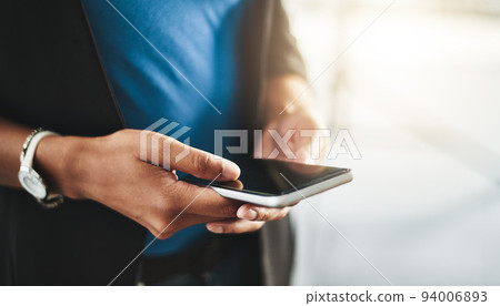 Businesswoman texting on phone, networking on social media and browsing internet at work. Closeup of the hands of a professional employee checking a text, scrolling an online app and reading messages Businesswoman texting on phone, networking on social media and browsing internet at work. Closeup of the hands of a professional employee checking a text, scrolling an online app and reading messages 94006893