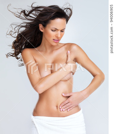 Portrait of topless young woman in severe pain 94006905