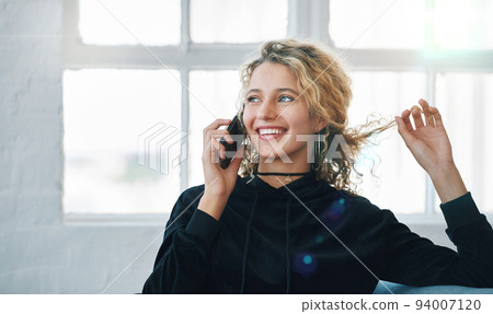 Beautiful woman using smartphone having phone call smiling enjoying conversation at home 94007120