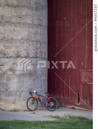 lightweight gravel bike against old barn 94007197