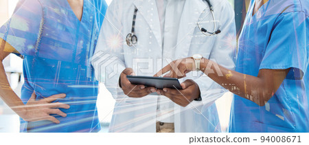 Healthcare, innovation and medical network with a group of nurses and a doctor using tablet to discuss ideas or health information database. Diversity, teamwork and future technology in a hospital 94008671